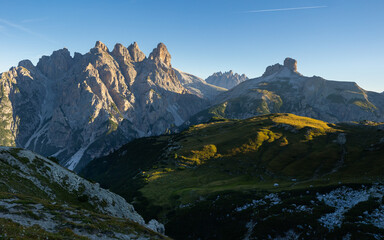 Amazing views of the picturesque high Dolomites mountains, lawns and summer forest