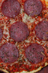Pizza with salami. Rustic style