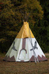 A closed Native American tepee outside in the woods. © lapis2380