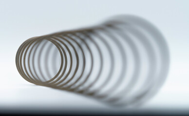 Cornucopia-like angular macro view of a spring with the distant end in focus, giving the optical illusion that it is the near end.