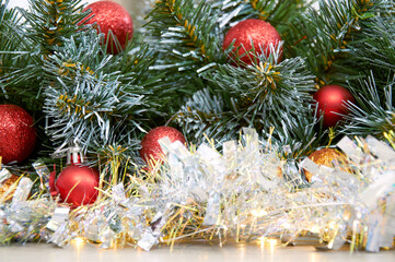 Christmas background with Christmas tree branches, red layers and silver tinsel. Christmas decorations
