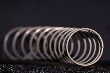 Angular macro view of a  spring showing its spiral, tubular design.