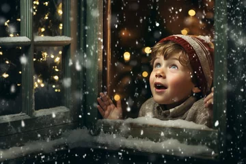 Fototapeten Winter wonderland: A child looks out a window the snow fall, filled with wonder and joy. Celebrating the Christmas season with excitement. © Casther