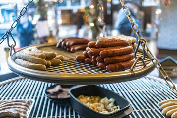 Grill with sausages on christmas market - obrazy, fototapety, plakaty