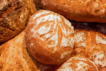 A loaf of freshly baked bread on the counter in a bakery. Close-up, selected focus. Bakery products. Production and sale of bread products