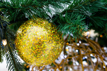Macro photo of golden ball on Christmas tree