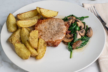 boneless pork chop  with sauteed spinach and mushrooms