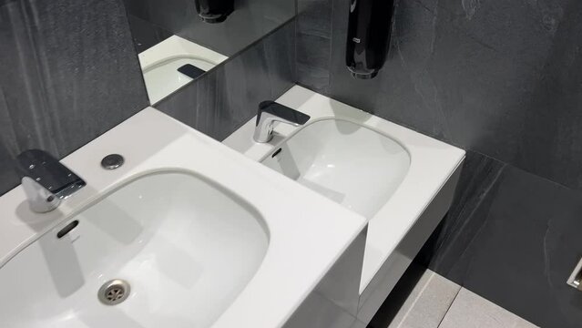 Rows of modern washbasins in a public restroom
