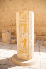 yellow hieroglyphs on rock outside hatshepsut temple in luxor egypt