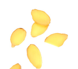 Flying slices of fresh ginger root on white background