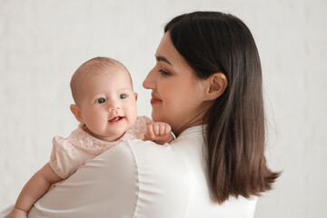 Young woman with her baby in bedroom, closeup