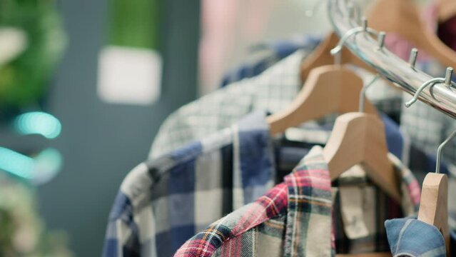 Zoom in shot on cheap and sustainable clothing from zero waste shopping outlet saving clothes from reaching landfill. Close up shot of elegant men shirts in eco friendly second hand store