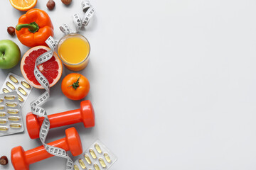 Composition with dumbbells, measuring tape, pills and healthy food on grey background