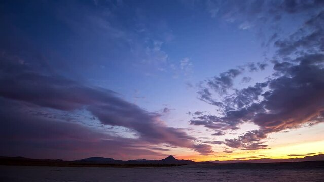 Day to night holy grail timelapse of colorful sunset to the stars in the Utah desert.