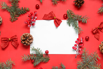 Fototapeta na wymiar Composition with blank card, fir branches and beautiful Christmas decorations on red background