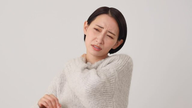 肩こりの中年女性　白背景