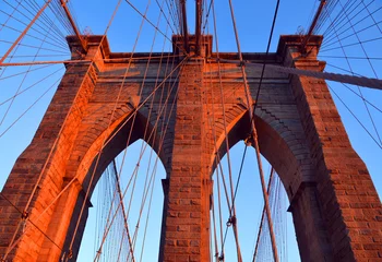 Foto op Plexiglas  Brooklyn Bridge is one of the oldest suspension bridges in the US. Completed in 1883, it connects the New York City boroughs of Manhattan and Brooklyn by spanning the East  © Daniel Meunier