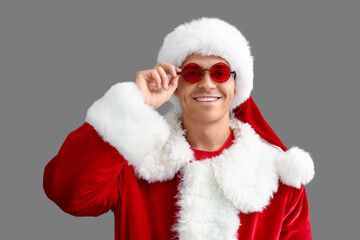 Santa Claus in glasses on grey background