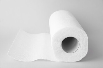 One roll of paper towels on light grey background, closeup