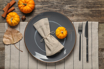Stylish autumn table setting on wooden background, flat lay