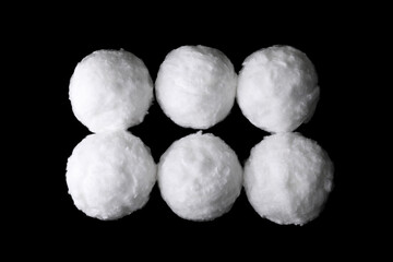 Balls of clean cotton wool on dark background, flat lay