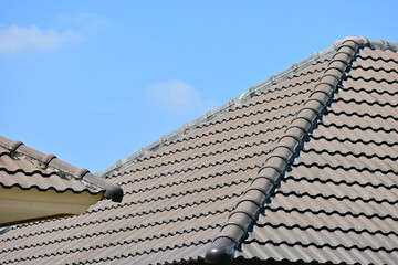 grey roof tile of house on blue sky and white cloud background