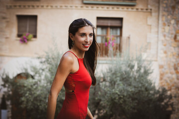Mujer con vestido rojo, posa para retrato en un bonito pueblo de España. 50 mm