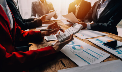 Financial analysts analyze business financial reports on a digital tablet planning investment project during a discussion at a meeting of corporate showing the results of their successful teamwork.