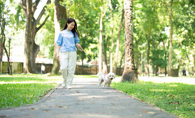 Photo of young Asian girl with her dog