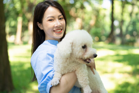 Photo of young Asian girl with her dog