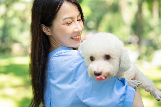 Photo of young Asian girl with her dog