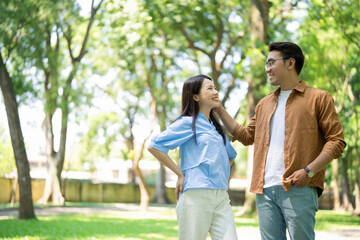 Photo of young Asian couple at park - obrazy, fototapety, plakaty