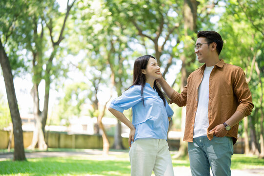 Photo of young Asian couple at park