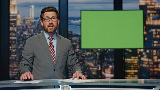 Professional television presenter ending evening newscast standing modern studio