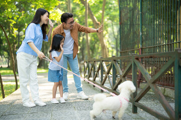 Photo of young Asian family at park - obrazy, fototapety, plakaty