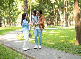 Obraz premium Photo of young Asian family at park