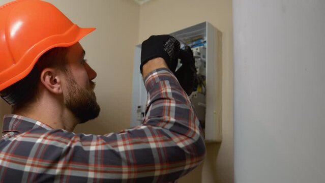 Professional Electrician Installing Electrical Box