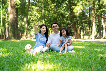 Fototapeta premium Photo of young Asian family at park