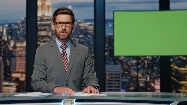 Serious anchor delivering news standing modern studio. Man host saying goodbye