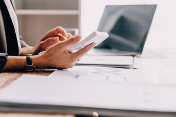 Businesswoman or accountant working Financial investment on calculator, calculate, analyze business and marketing growth on financial document data graph, Accounting, Economic, commercial concept.