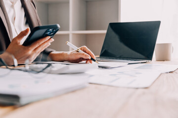 Businesswoman or accountant working Financial investment on calculator, calculate, analyze business and marketing growth on financial document data graph, Accounting, Economic, commercial concept.