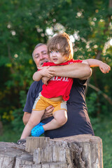 Grandson and grandfather playing on the river bank