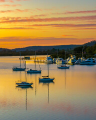 Aerial sunrise over the calm water with boats