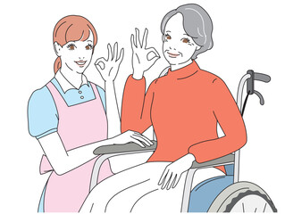 笑顔で車椅子に乗る上品なシニア女性と介護士
