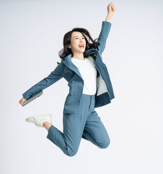 Image of young Asian business woman on background