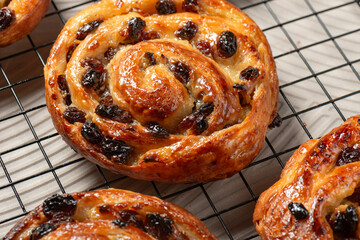 Pain aux raisins, also called escargot or pain russe, is a spiral pastry often eaten for breakfast in France. Its names translate as raisin bread, snail, and Russian bread respectively. - obrazy, fototapety, plakaty