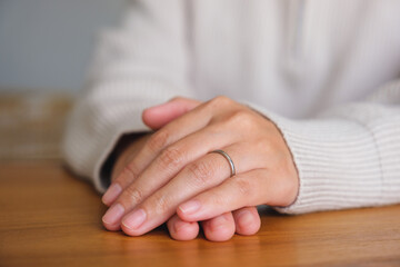 Closeup image of a woman wearing silver ring on her finger