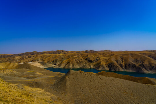 A deserted part of the Zaamin nature reserve in Uzbukistan on a sunny summer day. View of the mountains and reservoir.