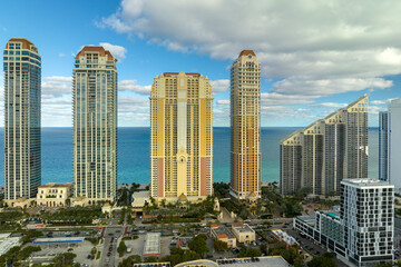 Obraz premium Aerial view of Sunny Isles Beach city with luxurious highrise hotels and condos on Atlantic ocean shore. American tourism infrastructure in southern Florida