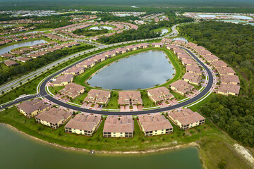 Aerial view of tightly located family houses with retention ponds to prevent flooding in Florida...